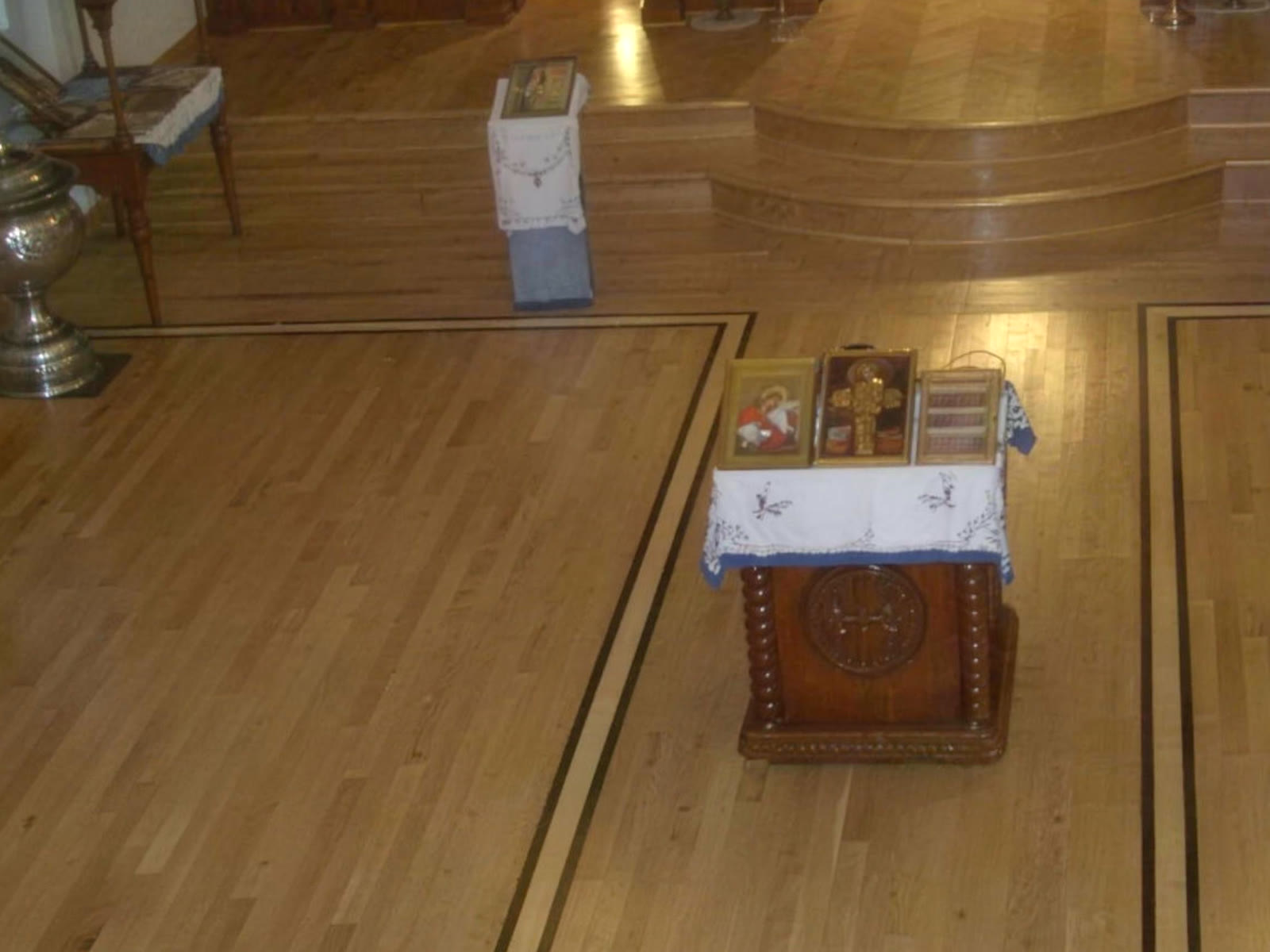 Custom walnut border inlay installed by Floors by Jimmy Connors in a church sanctuary