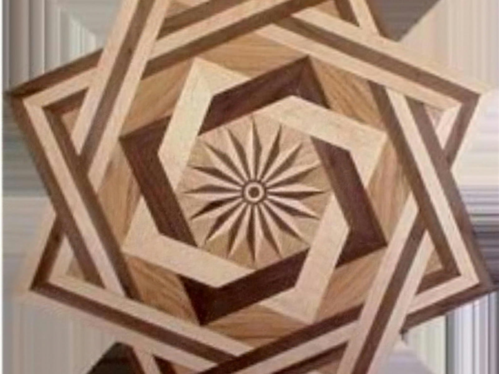Intricate inlaid hardwood floor medallion in contrasting species